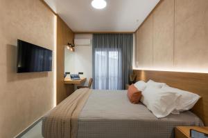 a hotel room with a bed and a television at Amara Local Experience in Chania Town