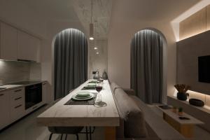 a kitchen with a table with plates and wine glasses at Amara Local Experience in Chania Town