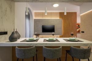 a kitchen and dining room with a table and chairs at Amara Local Experience in Chania Town