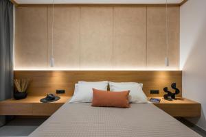a bedroom with a large bed with a wooden headboard at Amara Local Experience in Chania Town