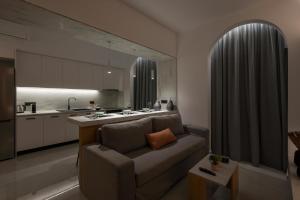a living room with a couch and a kitchen at Amara Local Experience in Chania Town