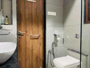 a bathroom with a toilet and a sink at Pvr House Ahmedabad in Ahmedabad +16 photos