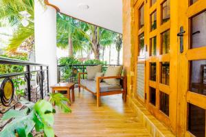 a porch with a couch and a chair on a balcony at Seaesta 2 bedroom b at Savannah in Ukunda