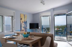 a living room with a table and a couch at Kassandra in Sivota