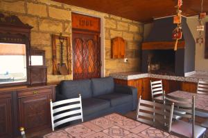 a living room with a couch and a stove at Above The Harbour solar-powered accommodation in Mossel Bay