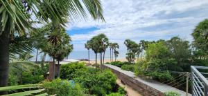 a view of a beach with palm trees at Angel Beach Villas - Pondicherry in Puducherry