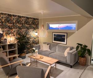 a living room with a couch and a table at Exclusive view villa in Tromsø
