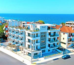 a large white building next to the ocean at Sky Boutique Hotel in Perea