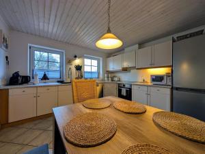 a kitchen with a wooden table with two plates on it at Hygge am See in Aventoft