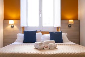 A bed or beds in a room at Kaliè Rooms Guest House