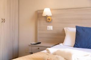 A bed or beds in a room at Kaliè Rooms Guest House