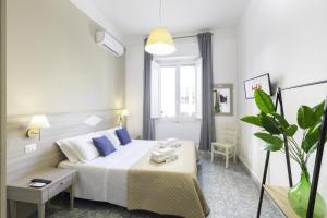 A bed or beds in a room at Kaliè Rooms Guest House