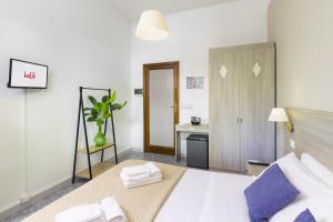A bed or beds in a room at Kaliè Rooms Guest House
