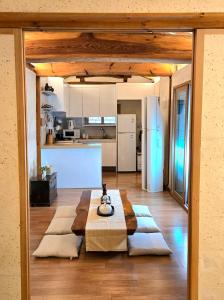 a living room with a table and a kitchen at JoongRimJae - Hanok in Seoul