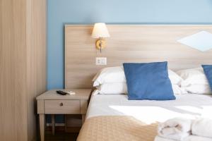 A bed or beds in a room at Kaliè Rooms Guest House