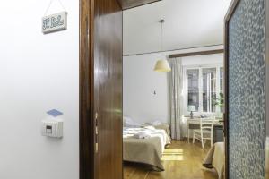 A bed or beds in a room at Kaliè Rooms Guest House