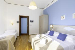 A bed or beds in a room at Kaliè Rooms Guest House