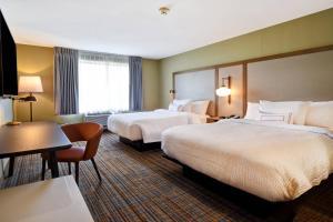 a hotel room with two beds and a desk at Fairfield Inn & Suites by Marriott Milwaukee North in Glendale +11 photos