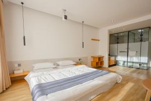 Voodi või voodid majutusasutuse Shangri-La Jinwushe Boutique Inn toas