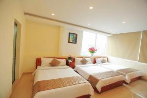 Postel nebo postele na pokoji v ubytování Hotel Phạm Duy