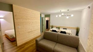 a living room with a couch and a bed at Lys Apartment in Gressoney-la-Trinité