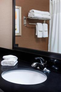 a bathroom with a sink and a mirror and towels at Fairfield Inn & Suites by Marriott Galesburg in Galesburg +12 photos