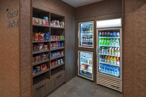two refrigerators in a room with food and drinks at Fairfield Inn & Suites by Marriott Houston Missouri City in Missouri City
