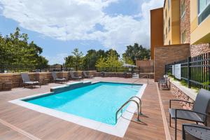 a swimming pool on a deck next to a building at Fairfield Inn & Suites by Marriott Houston Missouri City in Missouri City