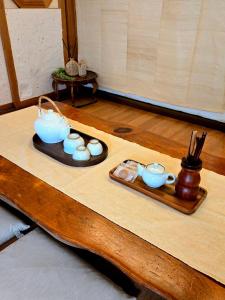 a table with a tray with tea cups and chopsticks at JoongRimJae - Hanok in Seoul +38 photos