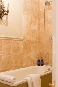 a bathroom with a bath tub and a sink at The Old Rectory in Hastings