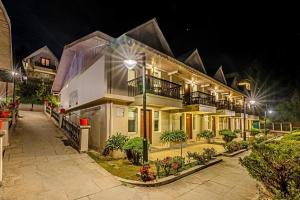 a large building with lights on it at night at Sterling Darjeeling in Darjeeling
