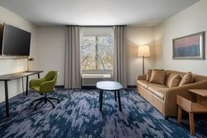 a living room with a couch and a table at Fairfield by Marriott Inn & Suites Louisville Shepherdsville in Louisville