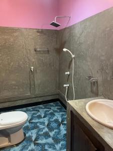 a bathroom with a toilet and a sink at Dili's Homestay in Kalpitiya +39 photos