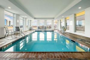 a large swimming pool with blue water in a building at Fairfield by Marriott Inn & Suites Louisville Shepherdsville in Louisville
