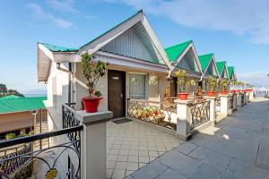 a row of houses with potted plants on a balcony at Sterling Darjeeling in Darjeeling