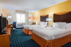 a hotel room with two beds and a flat screen tv at Fairfield Inn and Suites Mobile in Mobile +33 photos