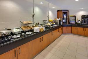 a kitchen with a counter with food on it at Fairfield Inn & Suites by Marriott San Francisco Airport in Millbrae +10 photos