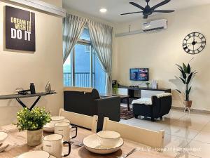 a living room with a table and a dining room at Ipoh Town CityView Premium Suite Kampung Paloh Residensi in Ipoh +15 photos