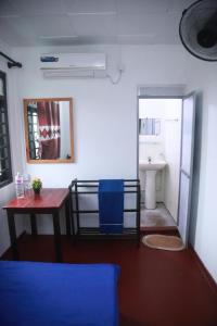 a room with a table and a bathroom with a sink at Ocean View Guest House in Ahangama
