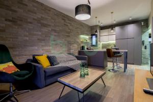 a living room with a couch and a table at Sea view luxury apartment in Alexandroupoli