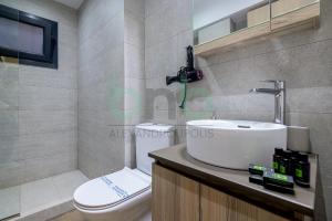 a bathroom with a sink and a toilet at Sea view luxury apartment in Alexandroupoli +48 photos