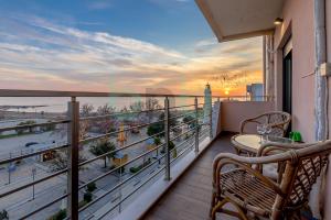 a balcony with a table and chairs and a view of the ocean at Sea view luxury apartment in Alexandroupoli
