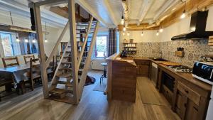 a kitchen with a ladder in the middle of a room at Gîte du Grand Cher in Les Rousses