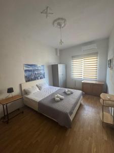 a bedroom with a bed with two towels on it at Peaceful house in Alexandroupoli