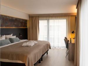 Кровать или кровати в номере Mercure Oostende