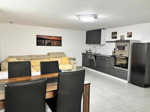 a kitchen and living room with a couch and a table at Ferienwohnung Annashome in Maxhütte-Haidhof +9 photos