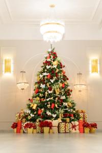 ein Weihnachtsbaum in einem Zimmer mit Geschenken in der Unterkunft Loft Inn SELF-CHECK IN in Vilnius