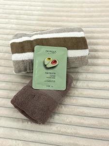 a book sitting on top of towels on a bed at By Room in Rumbula