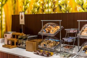 a buffet with several trays of pastries on a table at Fairfield Inn & Suites by Marriott Mobile Saraland in Saraland