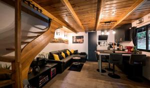 a living room with a couch and a table at Forest Escape with Jacuzzi & Pool Among the Trees by Destination GREEN Croatia in Ivanec